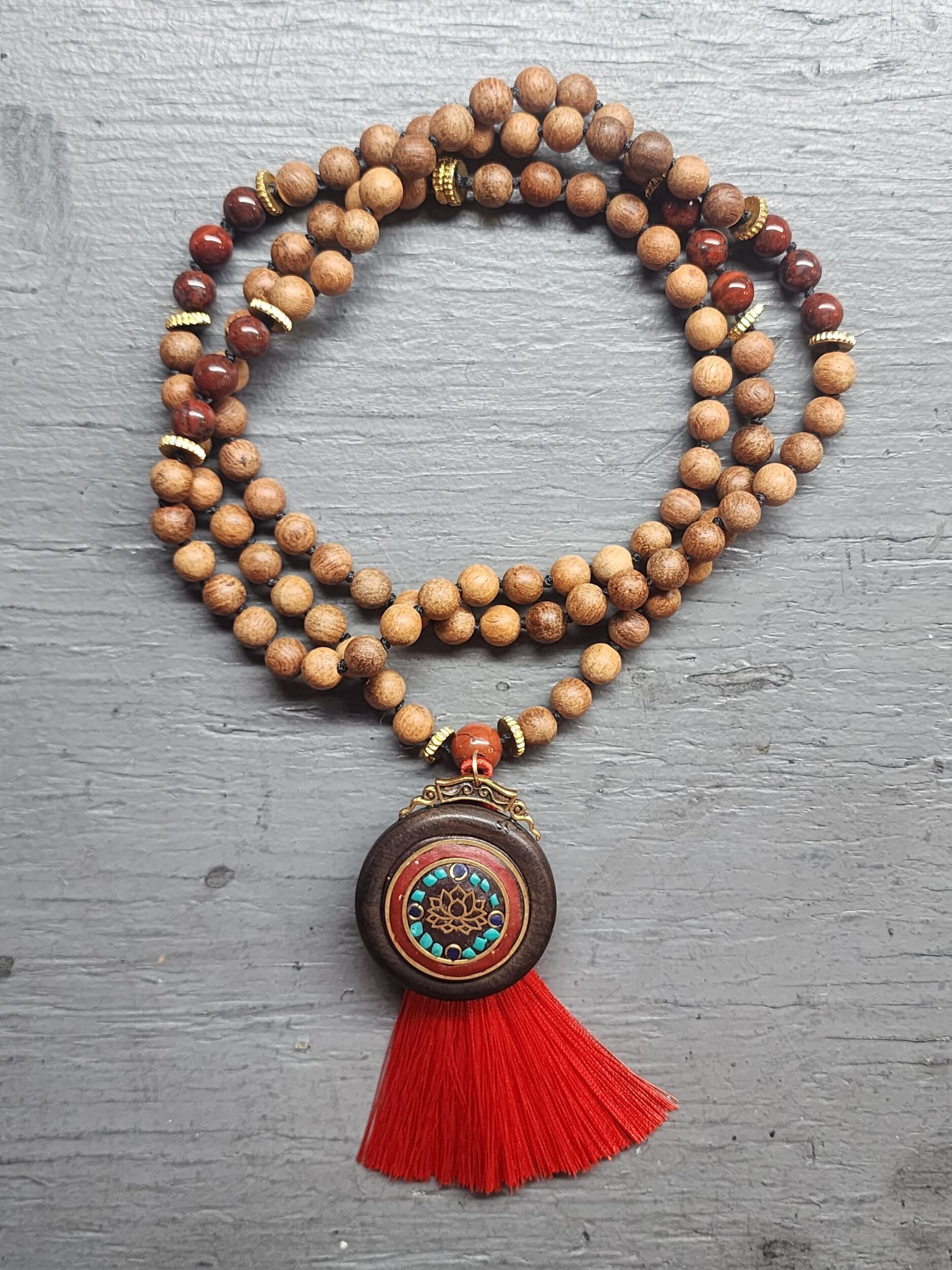Hand Knotted Red Jasper Mala featuring olive wood, lotus amulet, and a red tassel