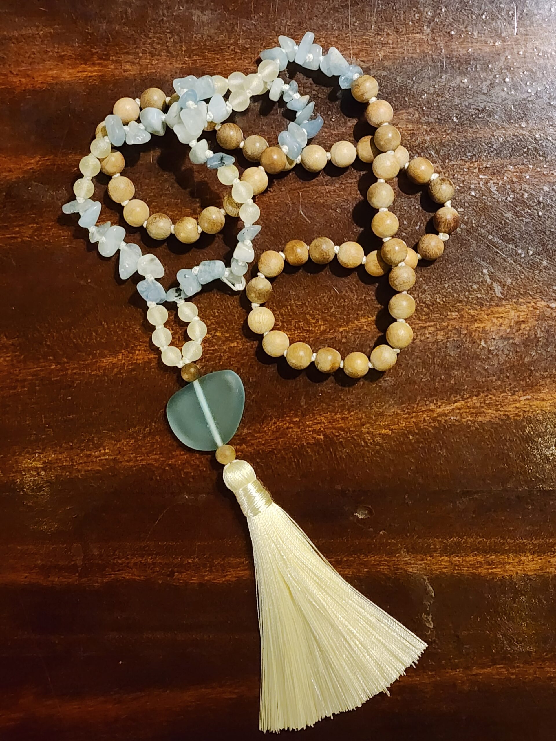 Hand Knotted Blue Lace Agate Mala featuring camphor wood, blue sea glass, and white tassel
