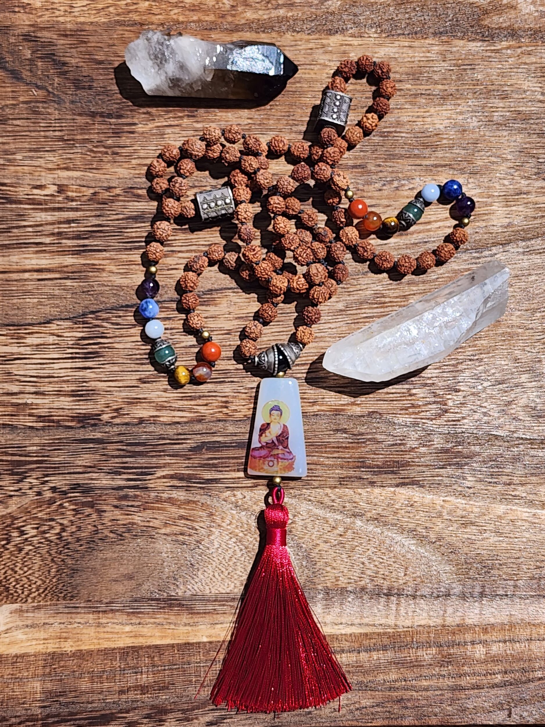 Hand Knotted Chakra Mala featuring Rudraksha seeds, Buddha amulet and maroon tassel