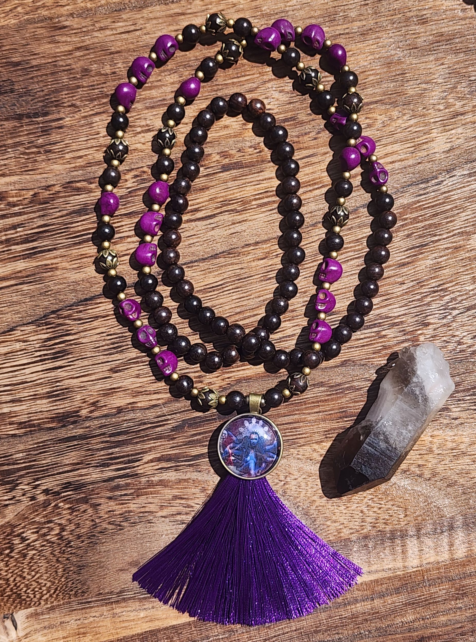 Kali Ma Mala featuring ebony wood, purple skulls, and purple tassel