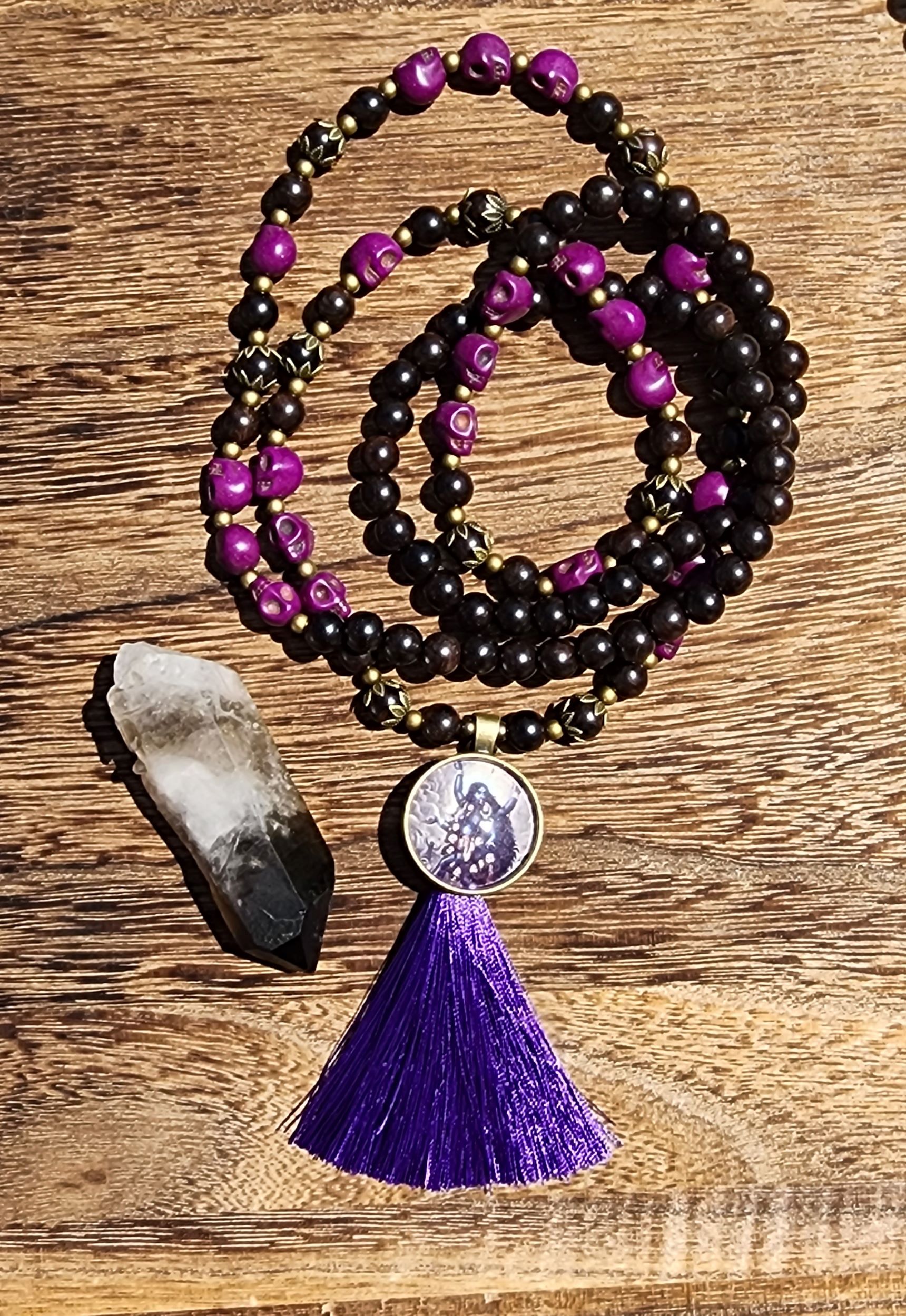 Kali Ma Mala featuring ebony wood, purple skulls, and purple tassel